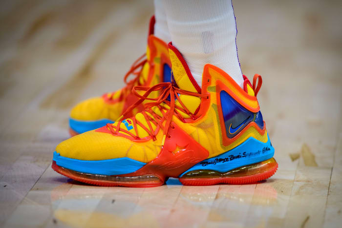 View of yellow, red, and blue Nike LeBron shoes.